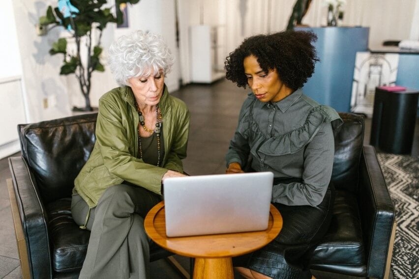 Two women looking at laptop at office